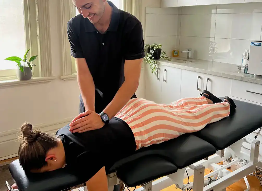 Treating a patient's mid back while they lie face down on an adjusting table