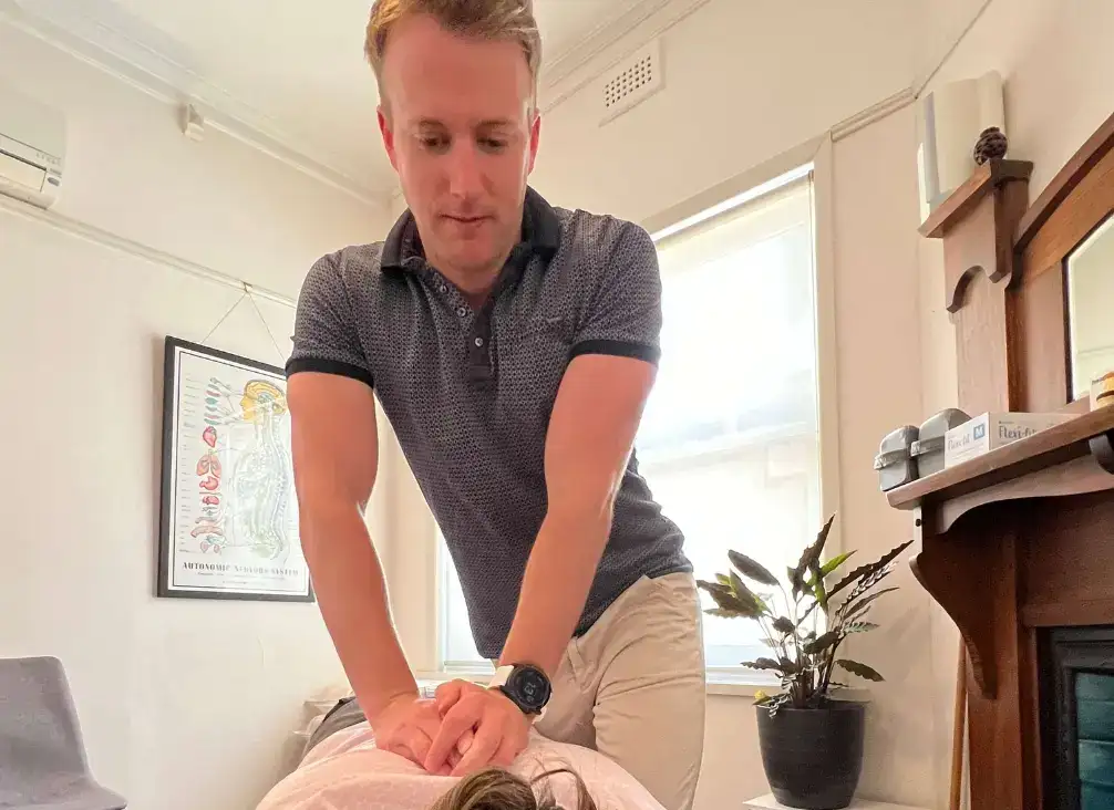 Dr Hamilton Mack treating a patient's upper back