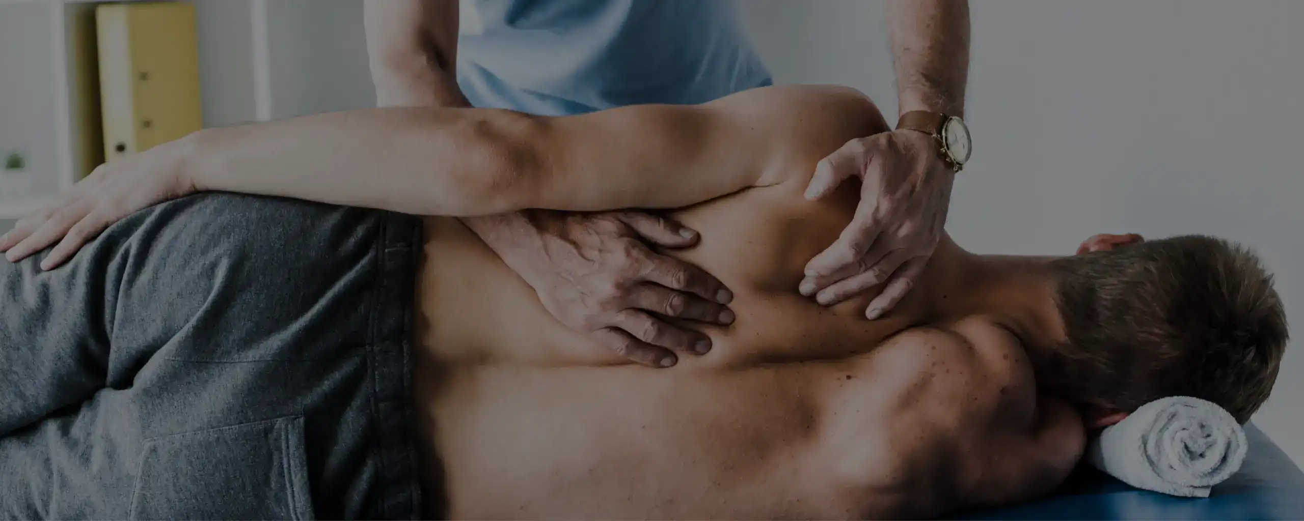 A chiropractor treating a patient's lower back in the Brunswick West clinic
