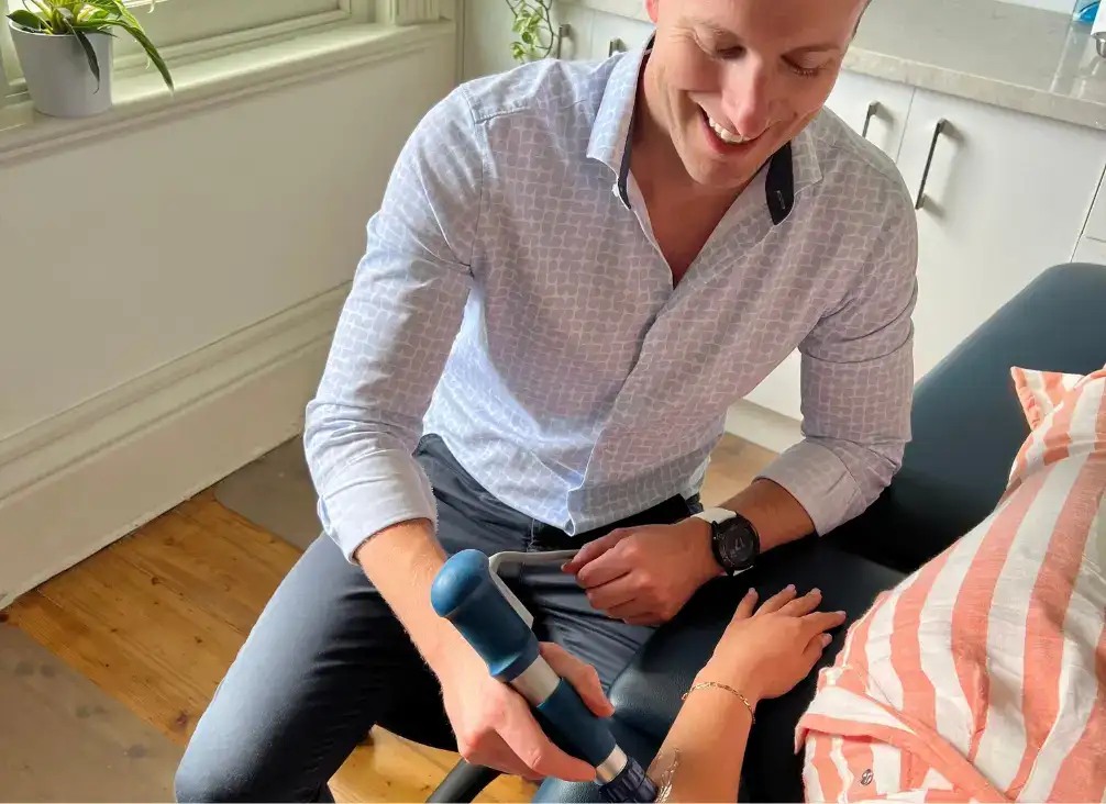 Dr Hamilton Mack assessing a patient's elbow
