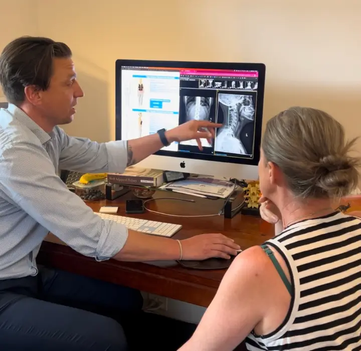 Chiropractor Melbourne explaining spinal X-rays during a first visit