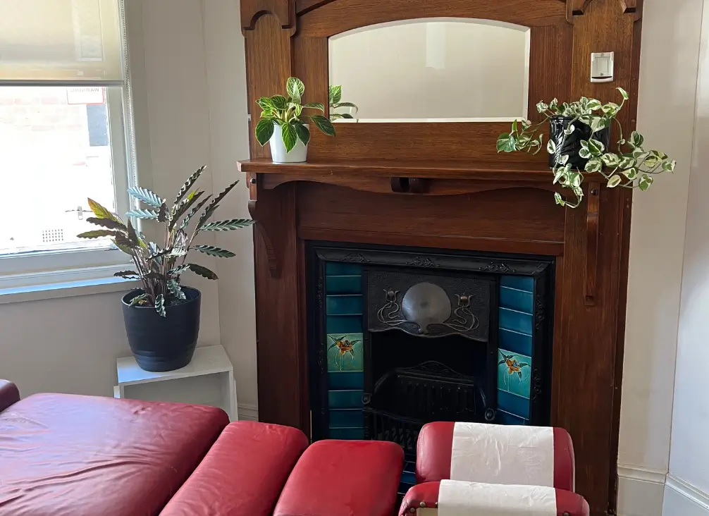 Chiropractor Melbourne treatment room with vintage fireplace and greenery