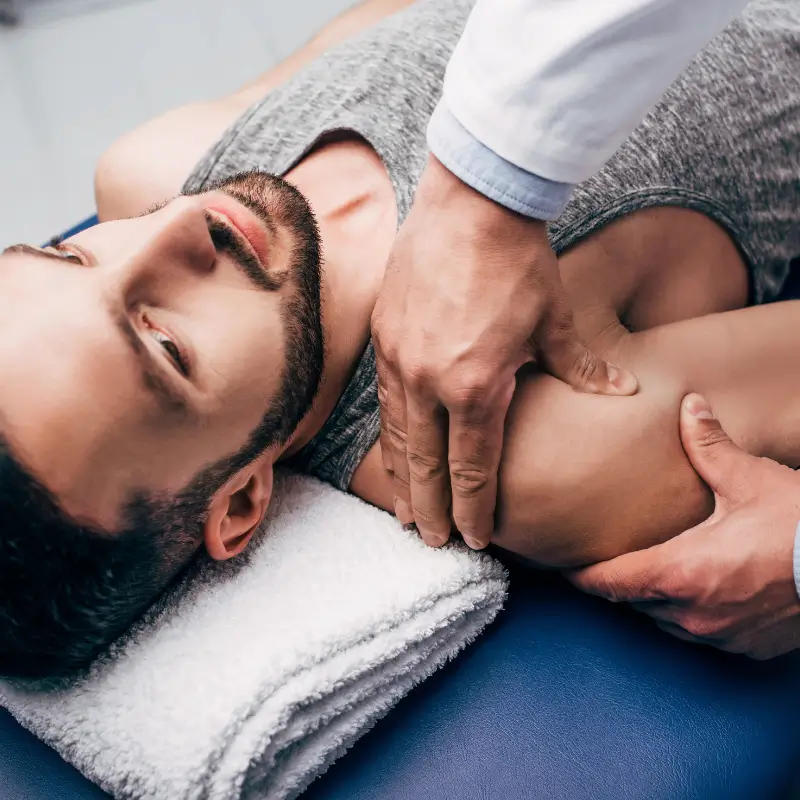 Chiropractor Melbourne providing shoulder pain treatment to male patient