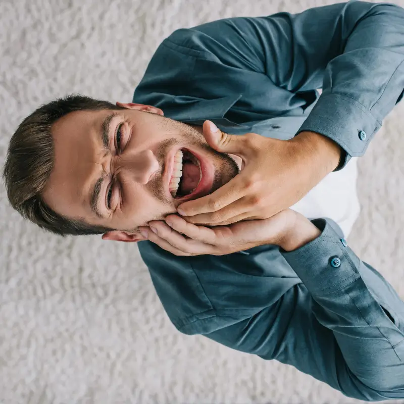 Man experiencing jaw pain in the morning from grinding teeth – Chiropractor Melbourne