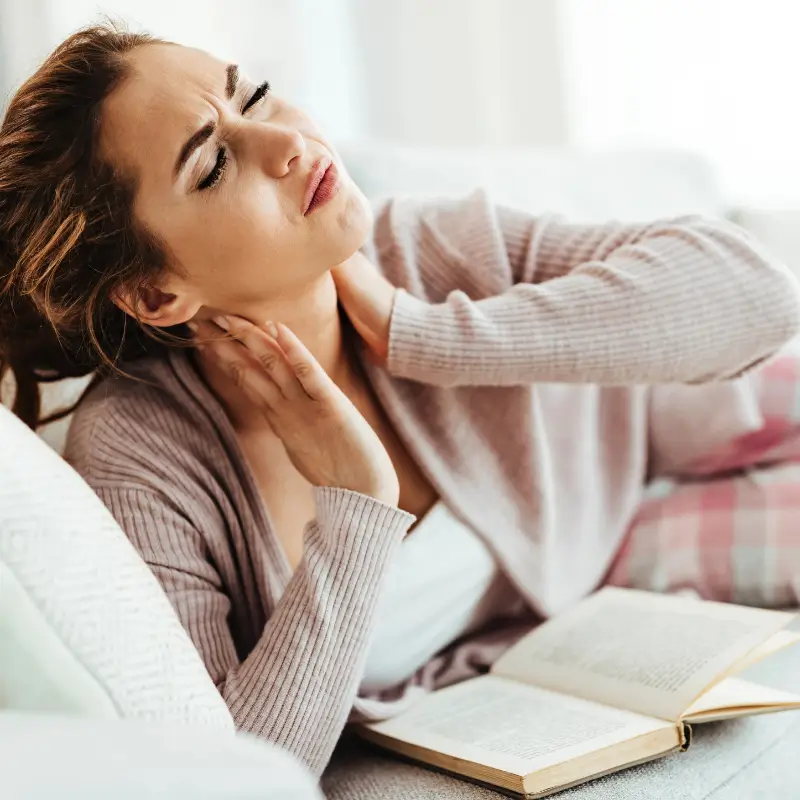 Woman experiencing neck pain at home – Chiropractor Melbourne support