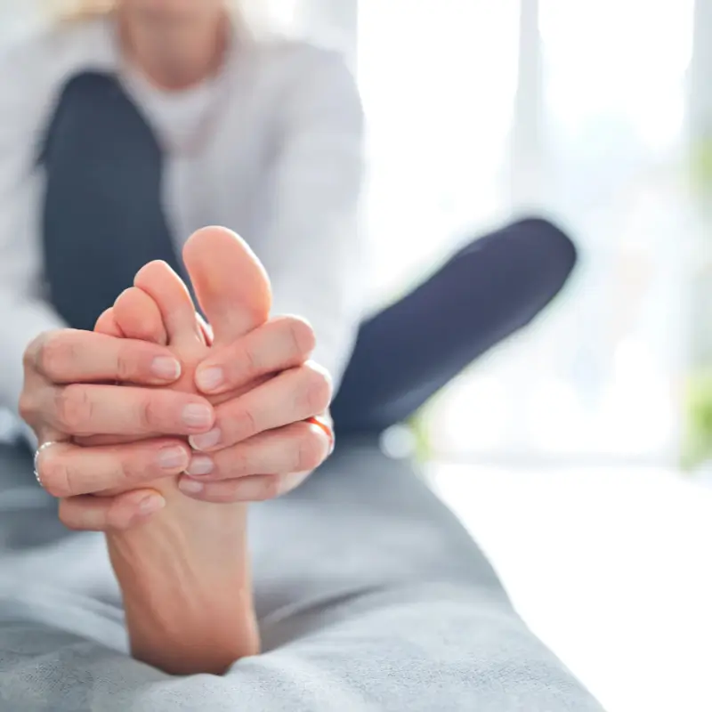Chiropractor Melbourne – Person holding foot indicating plantar fasciitis pain