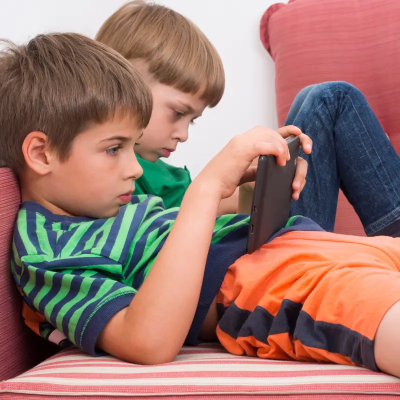 Kids slouching on sofa