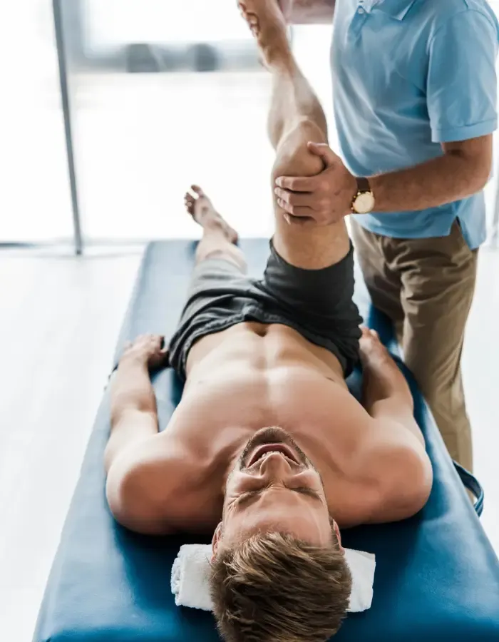 Chiropractor treating a runner's knee injury near the Maribyrnong River trail