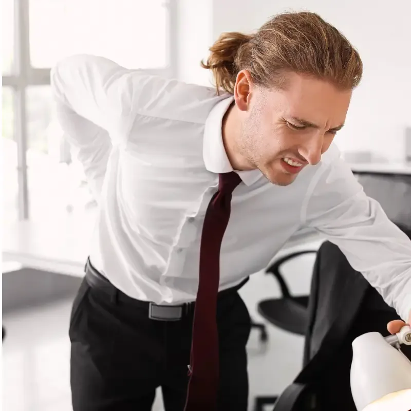 Chiropractor treating standing-related back pain for a DFO Essendon retail worker